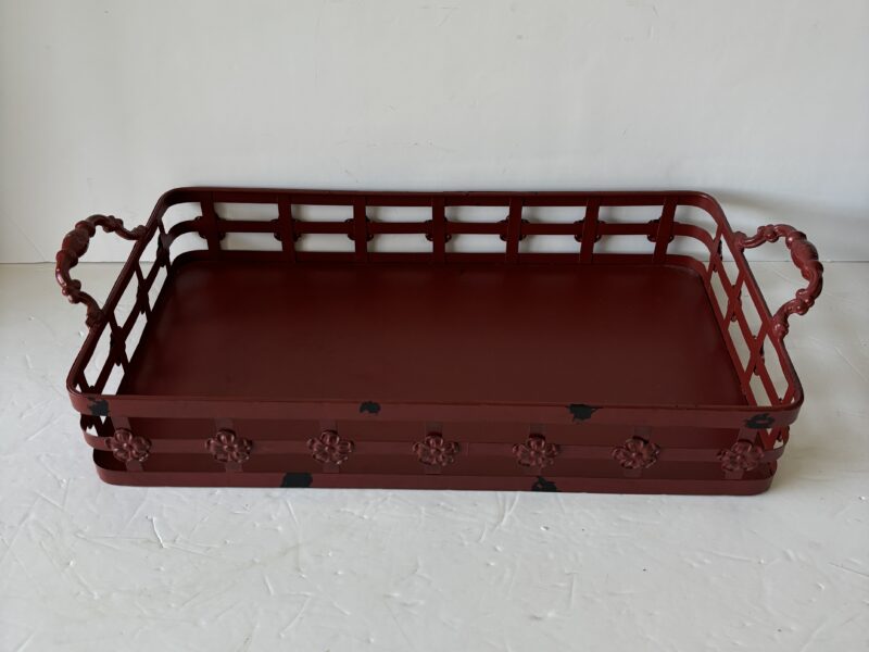 Red metal tray with handles and floral accent