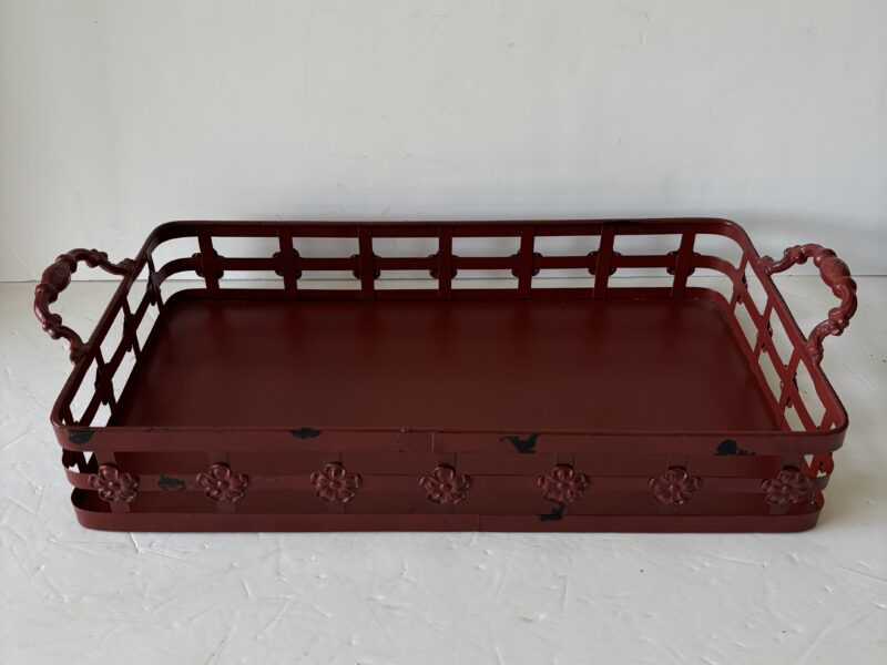 Red metal tray with handles and floral accent