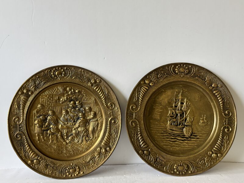 Pair of vintage 14" English Hammered Brass plates at dinner table and sailing ship
