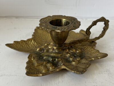 Solid brass candle holder with finger grip and grape cluster drip tray