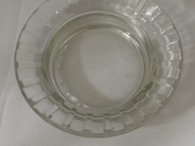 Round glass ashtray with fluted rim marked