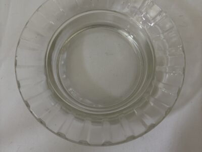 Round glass ashtray with fluted rim marked