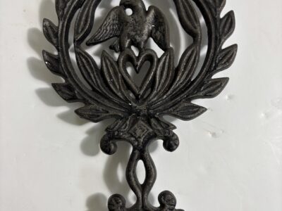 Vintage cast iron trivet with eagle